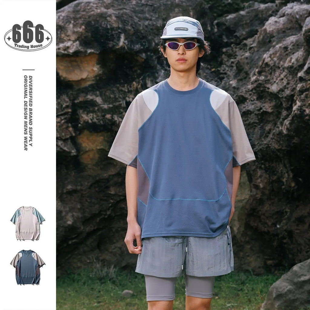 Men's loose fit blue patchwork sports T-shirt with raglan short sleeves on a hanger.