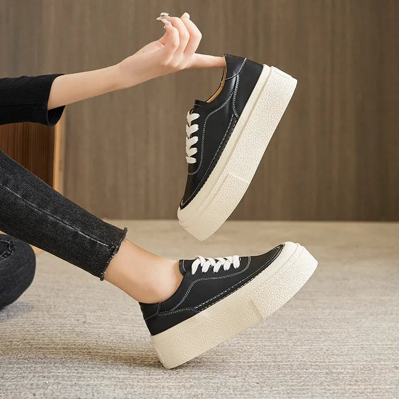 Women's black platform casual sports shoes with embossed leather upper and round toe.