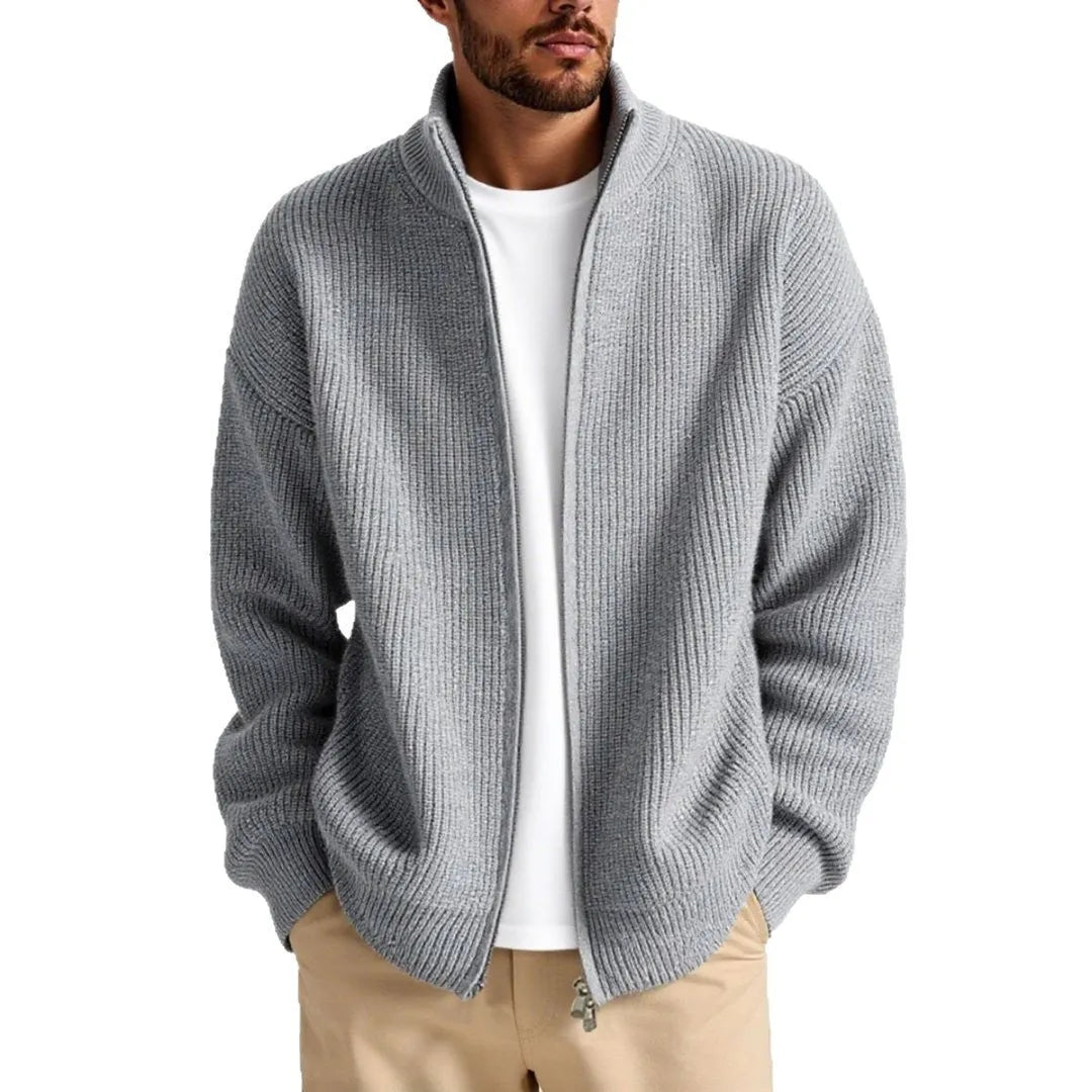 Man wearing a loose grey men's cardigan sweater, a casual acrylic knitwear piece for leisure.