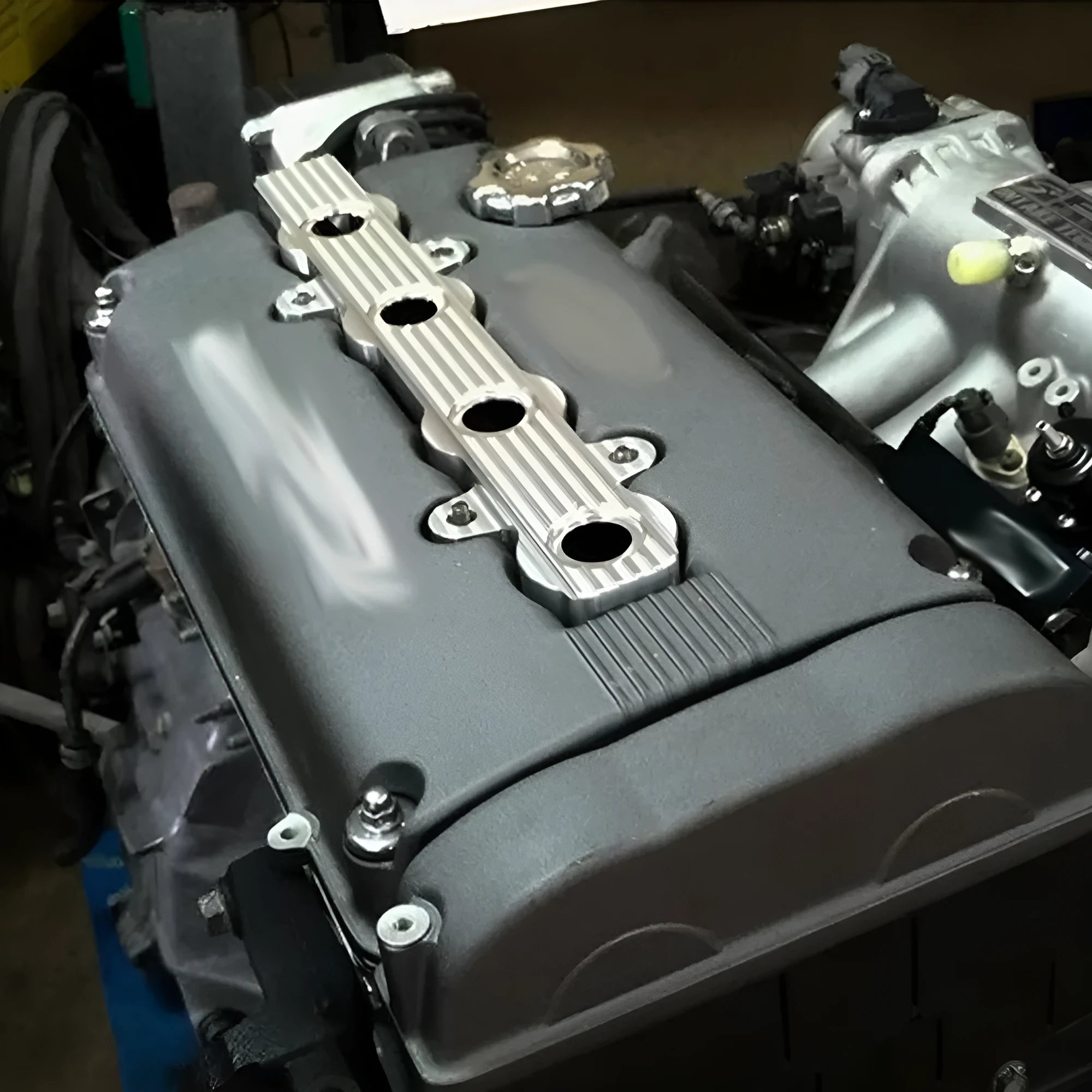 Aluminium engine housing panel in blue, red, and silver colours, showing versions with and without holes.