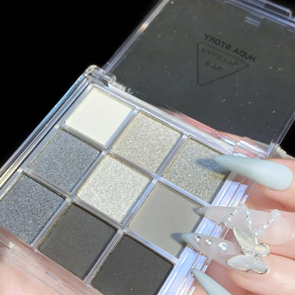 Smoked design nine-colour eyeshadow palette showing shades of white, silver, black, and iron grey.