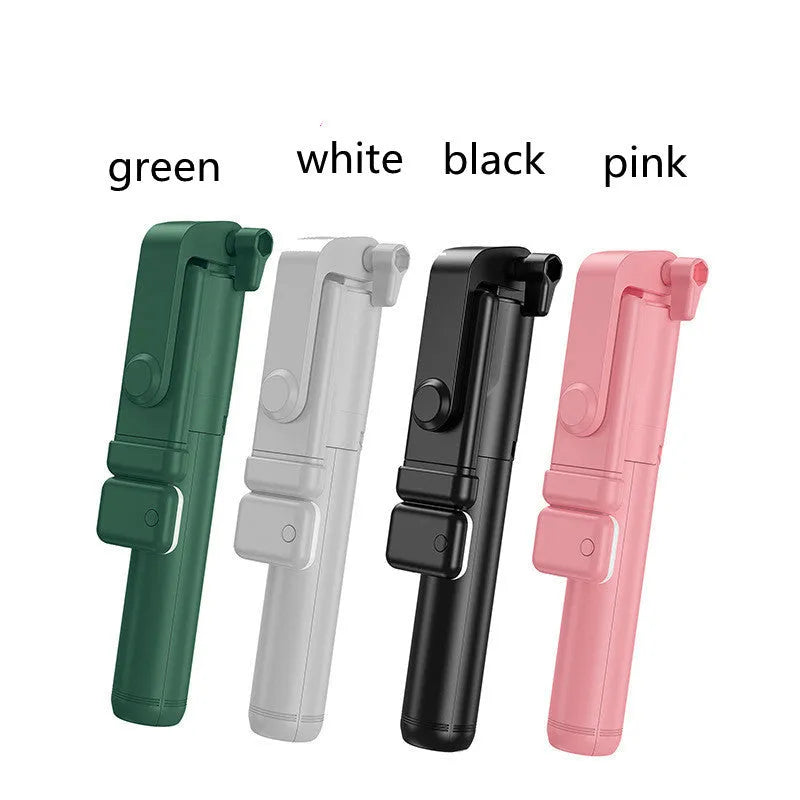 Black Bluetooth selfie stick with extended tripod legs, fill light, and a phone mounted in the 360-degree rotatable holder.