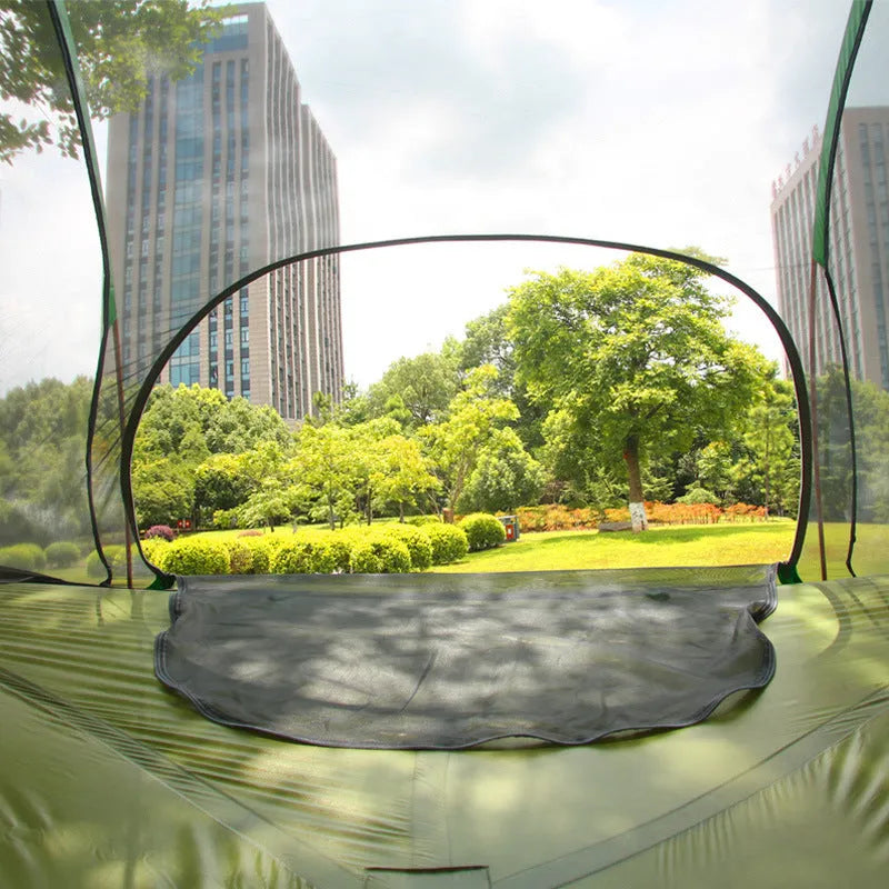 Self-driving tour camping hammock tent with aluminium pole and mosquito net suspended between trees in a forest setting