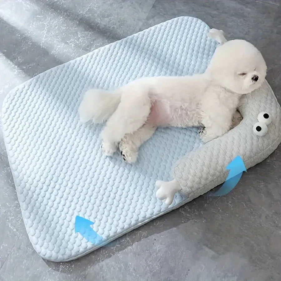 Blue pet cooling mat with big-eyed monster design on a wooden floor, shown in large (L) size.