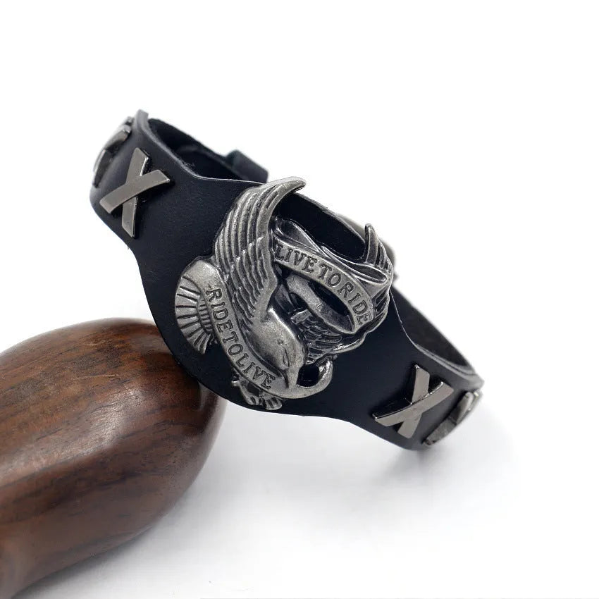 Black geometric leather bracelet with an eagle watch-button, showing tapered width.