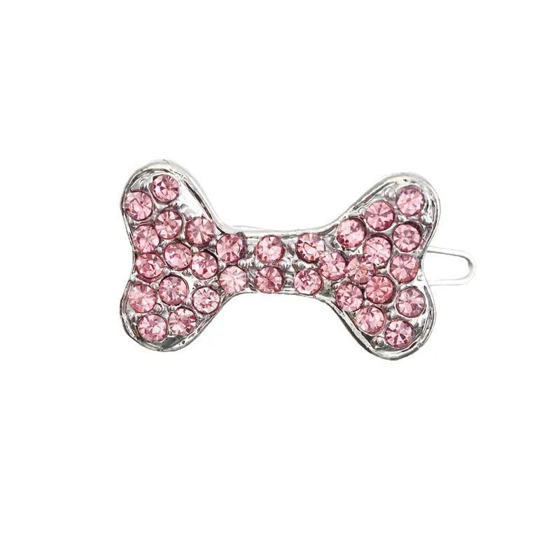 Rhinestone dog bone hair clip in alloy, white colour, on a neutral background