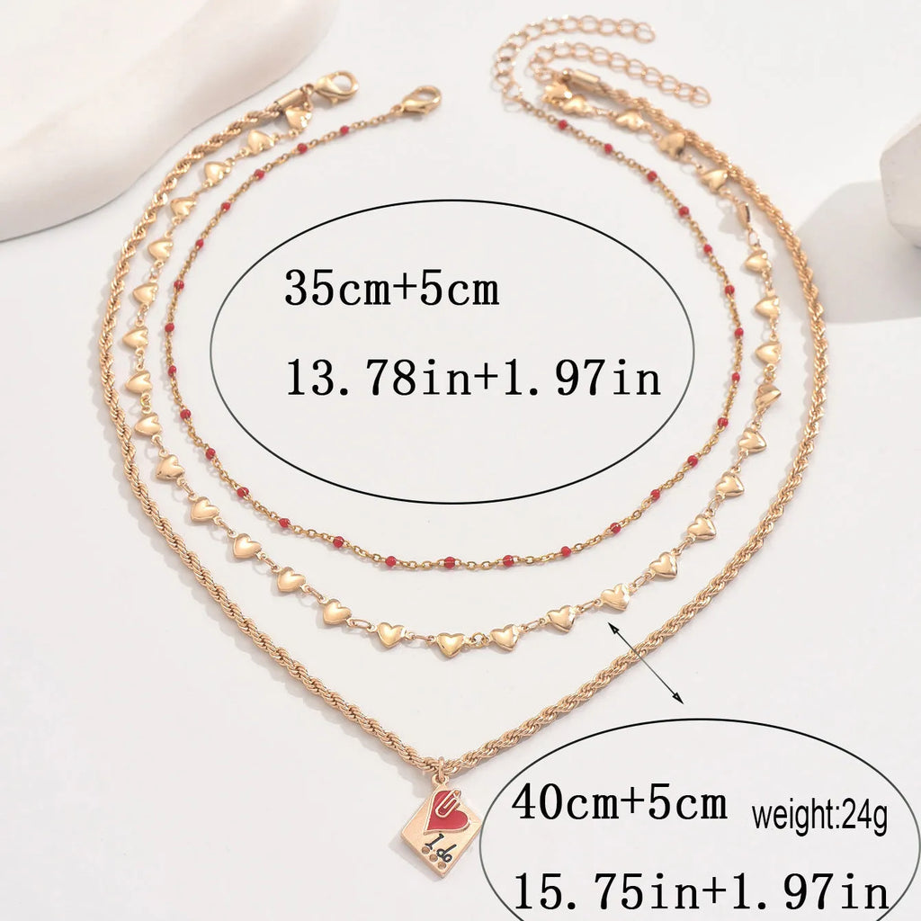 Geometric three-layer heart pendant necklace on a model, showing adjustable clavicle chain length.