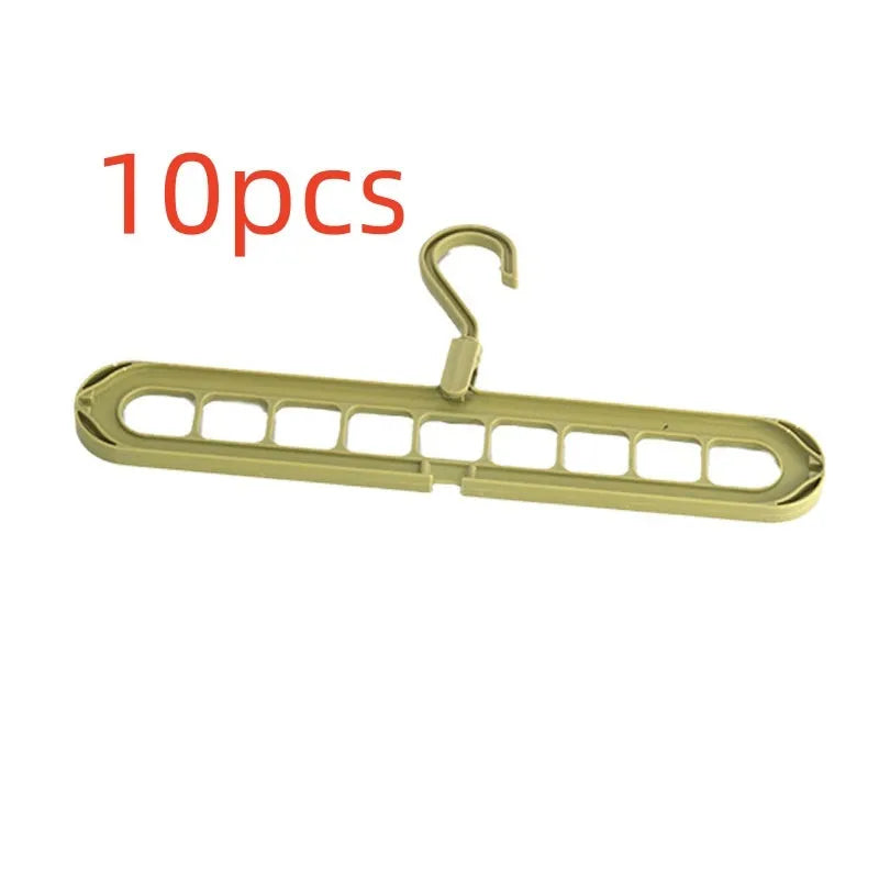 Green plastic nine-hole folding hanger for trousers shown in a dormitory wardrobe.