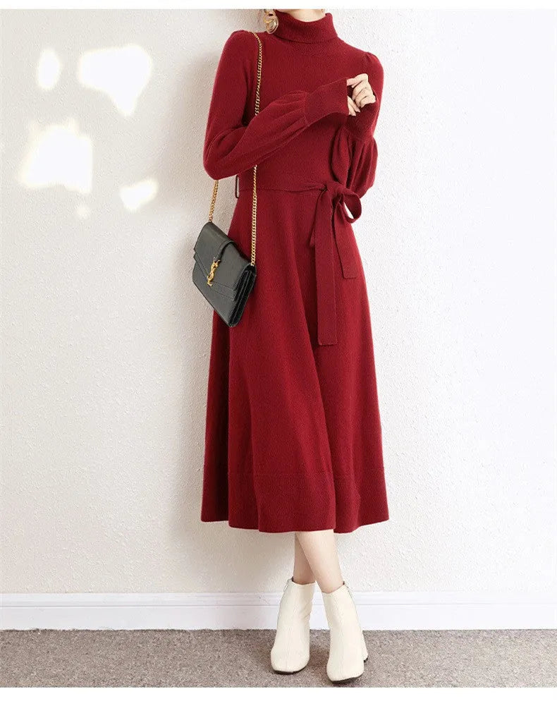 A rose red turtleneck knit dress with long sleeves, an elastic waist, and a loose mid-length skirt.