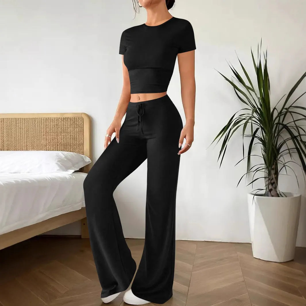 Black high waist trousers and short sleeve t-shirt women's co-ord set on a hanger.