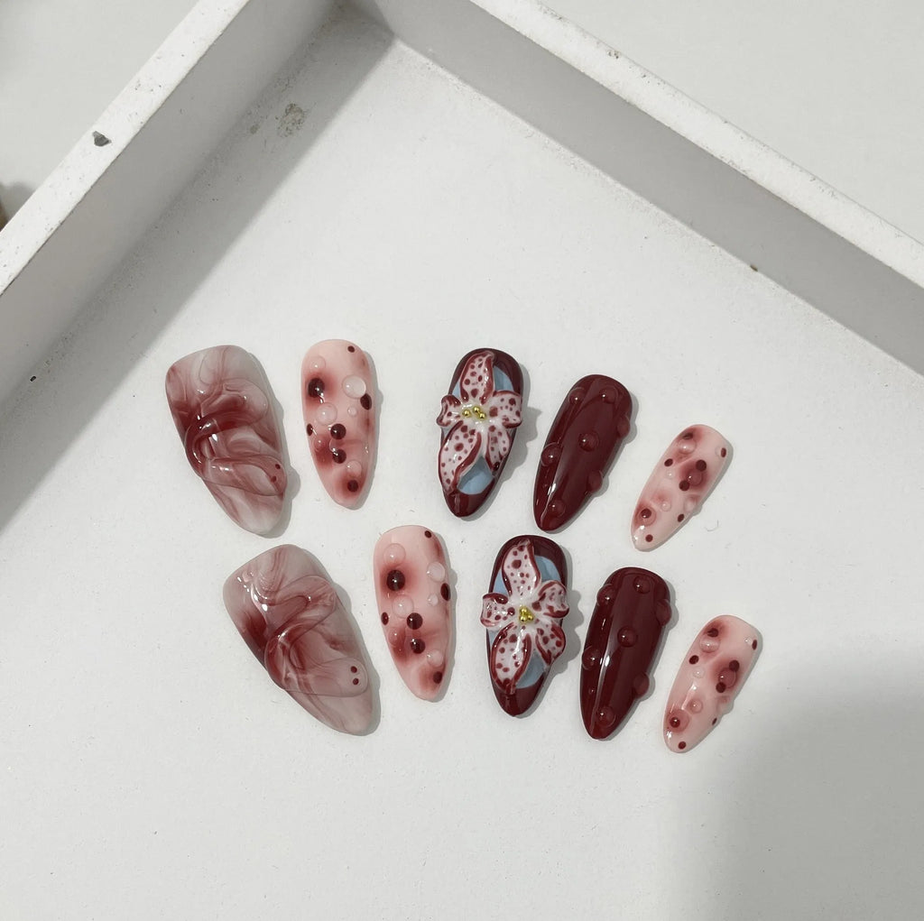 Almond-coloured false nails with hand-painted three-dimensional rose and tulip floral designs