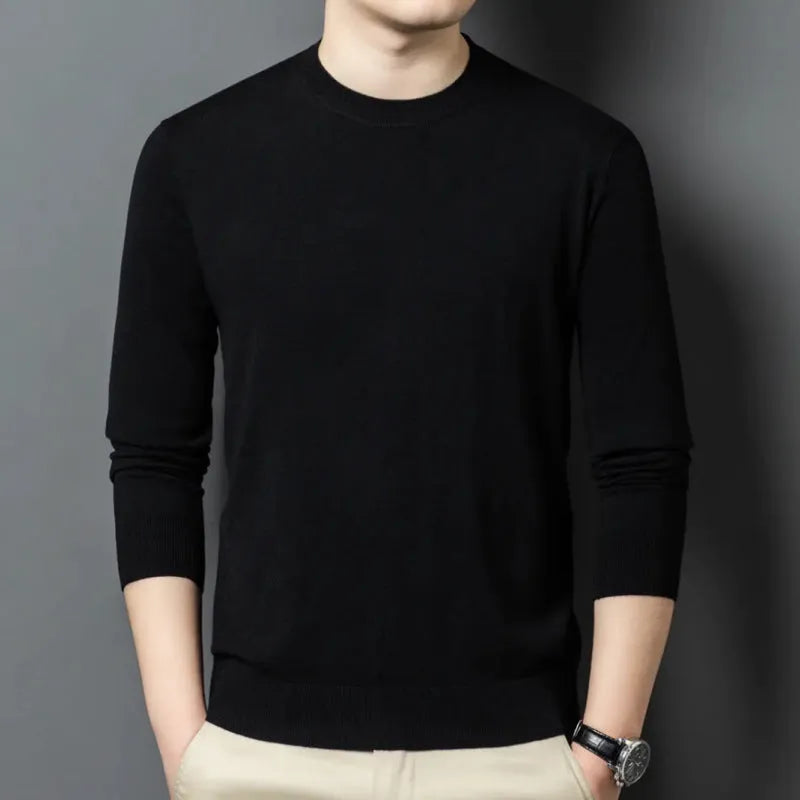 Man wearing a round neck long sleeve wool blend pullover sweater in a neutral colour.
