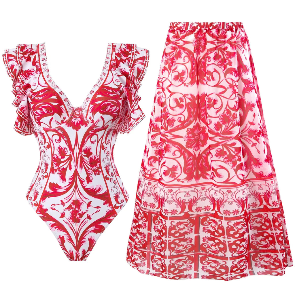 Adult woman modelling a printed one-piece swimsuit in a choice of colours including rose pink, blue, white, and a red apron set style.