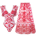 Adult woman modelling a printed one-piece swimsuit in a choice of colours including rose pink, blue, white, and a red apron set style.