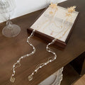 Women's gold hairpin with pearl, diamond flower decoration and long tassel details