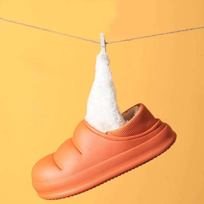 Green EVA waterproof garden slippers with non-slip sole and plush lining shown on wooden decking