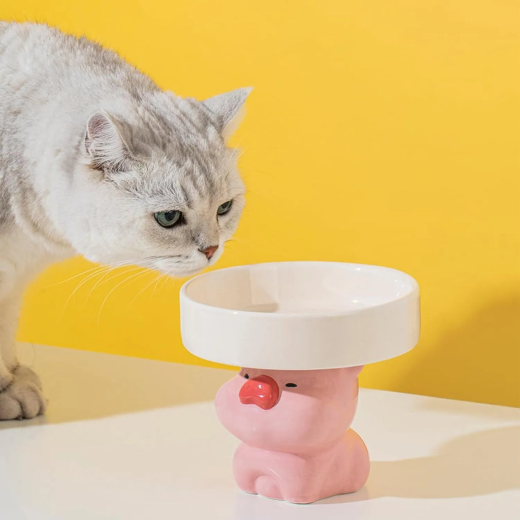 Raised ceramic cat food bowl in animal theme design, showing elevated height and wide bowl.