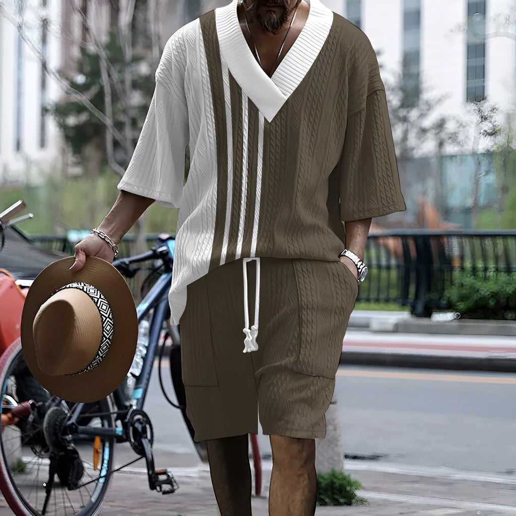 A man wearing a printed drop-shoulder knitted short-sleeved top with matching shorts in a casual setting.