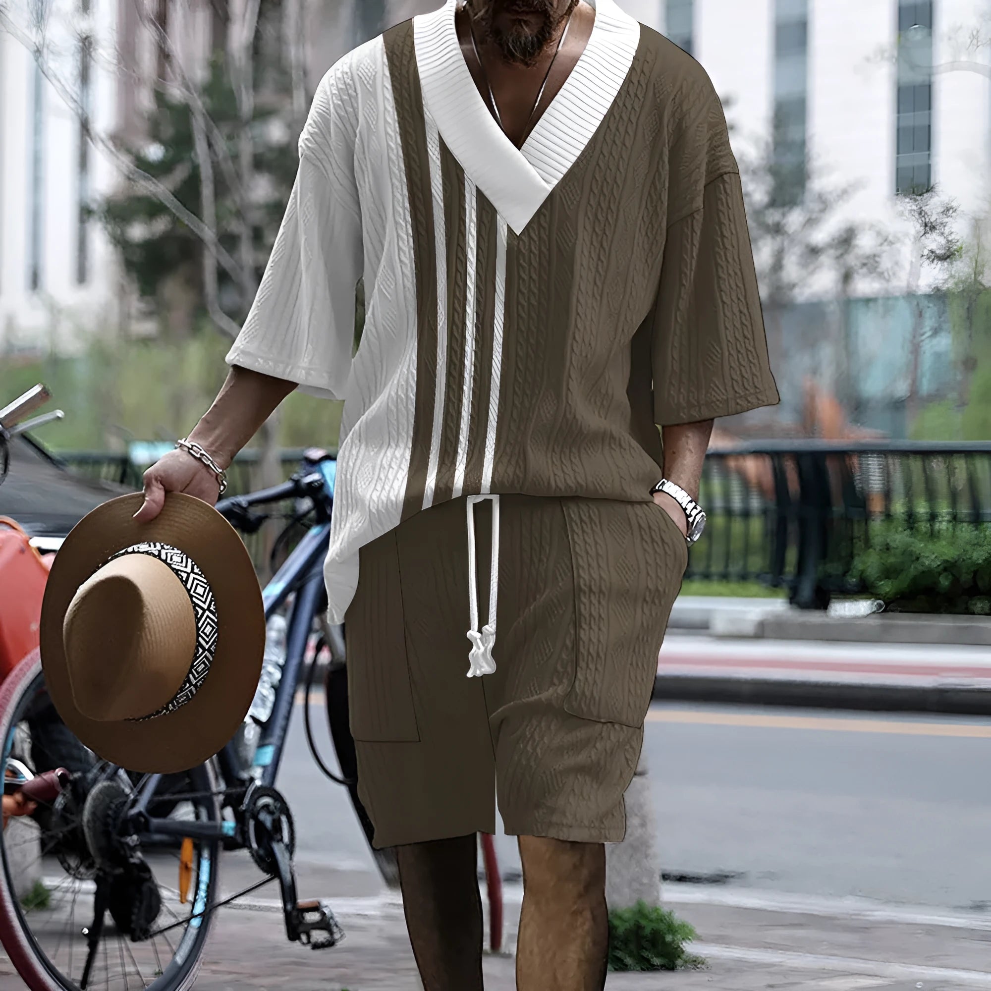 A man wearing a printed drop-shoulder knitted short-sleeved top with matching shorts in a casual setting.