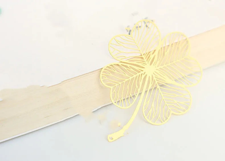 Brass metal bookmark with hollow leaf pattern design and rose gold tassel