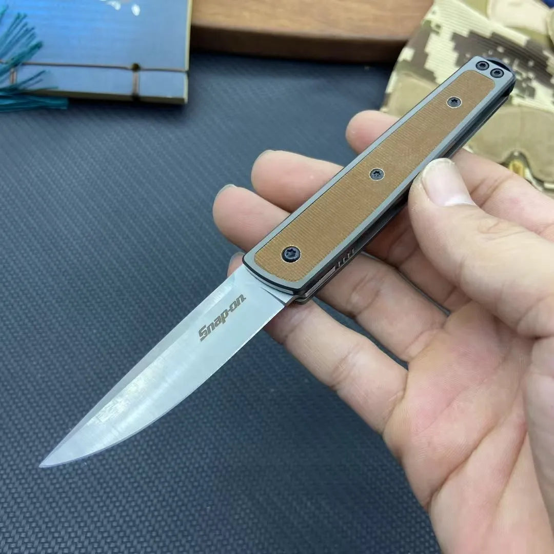 Closed and open views of a folding fruit knife with a coloured handle and stainless steel blade.