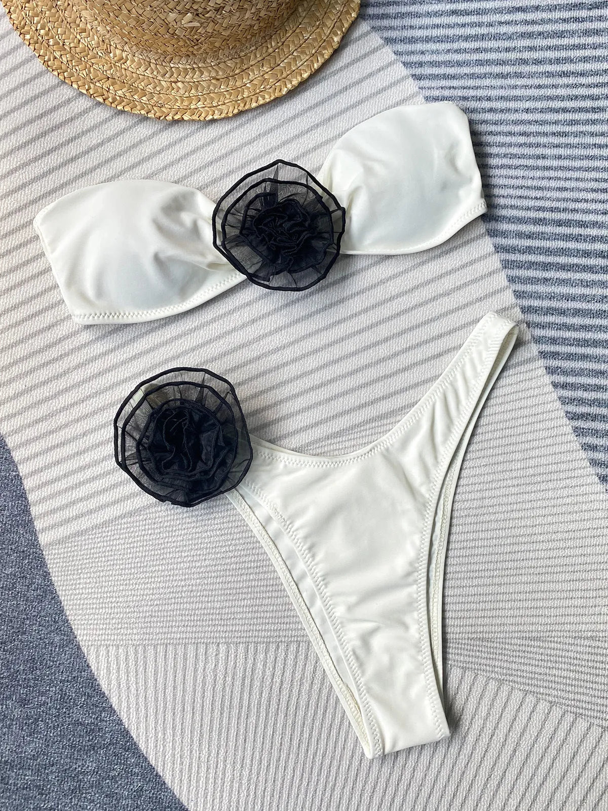 Striped bikini swimsuit with three-dimensional flower detail and split design, includes tube top and shorts.