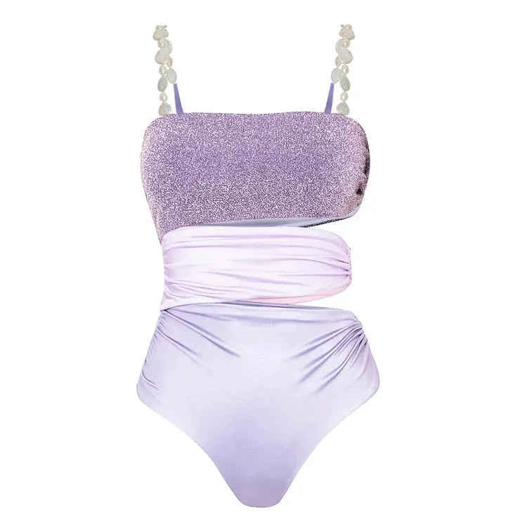 Purple women's one-piece swimsuit with hollow design and matching wrap skirt.