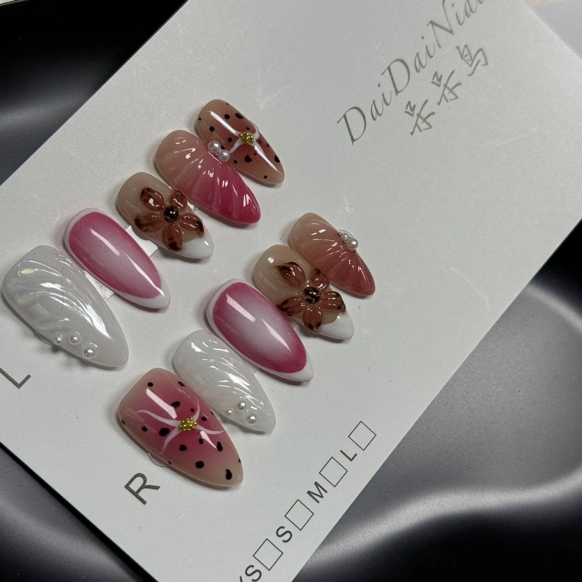 Hand-painted three-dimensional carved nail beauty patches showing embossed and candy patterns on almond-shaped nails