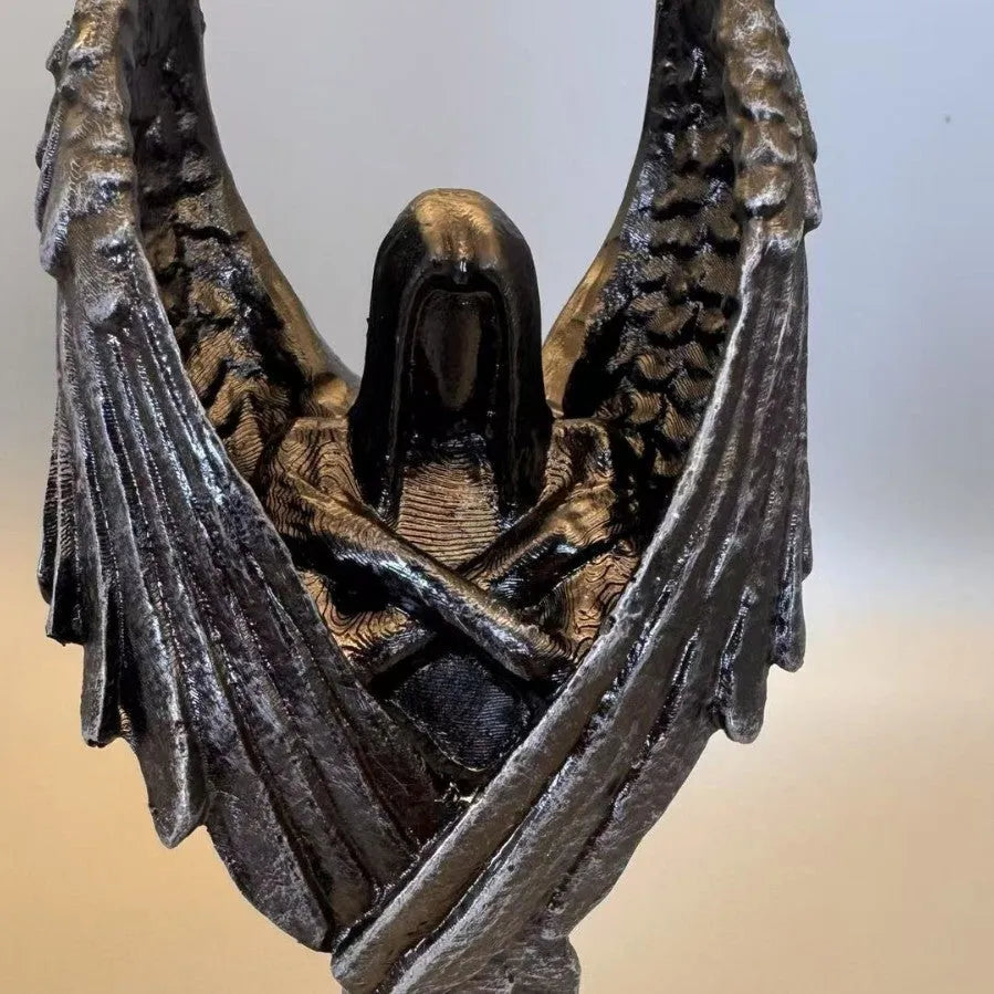 Dark angel resin statue ornament on a shelf, showing detailed sculptural form and dark colour finish.