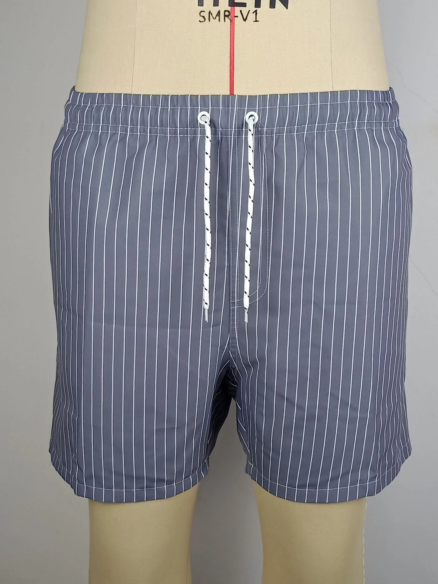 Polyester fibre striped beach shorts with straight leg opening and triangle lining design in multiple colours