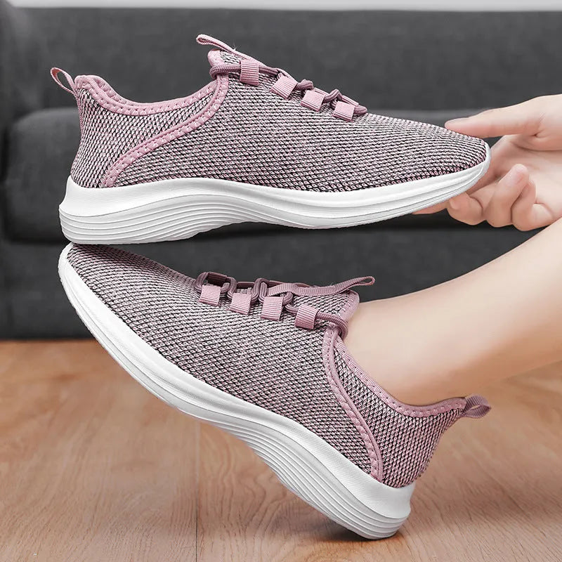 Women's low-top Flyknit mesh sneaker in black with round toe and lace-up front.