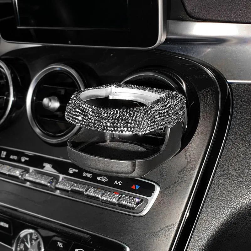 White diamond-encrusted ABS plastic car cup holder bracket mounted on a car air vent.