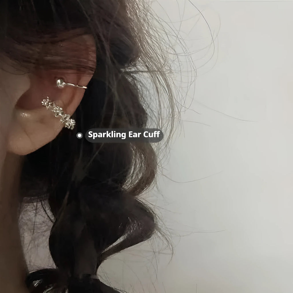 A pair of silver geometric irregular-shaped earrings with a frosted finish and clip-on fastenings.