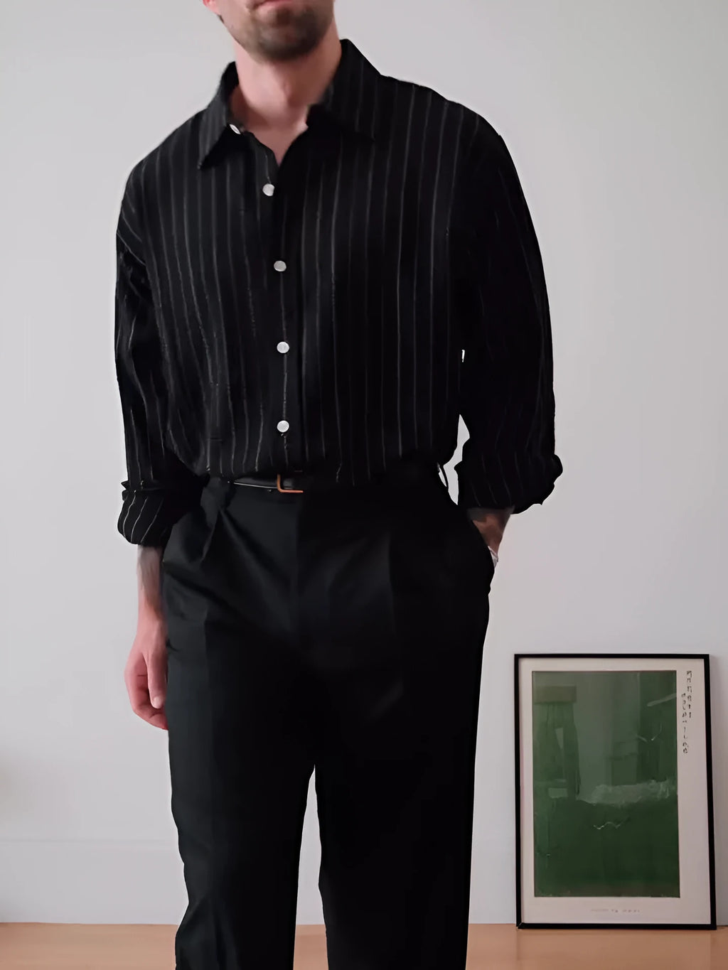 Black pinstriped button-down men's shirt with striped pattern on polyester fabric