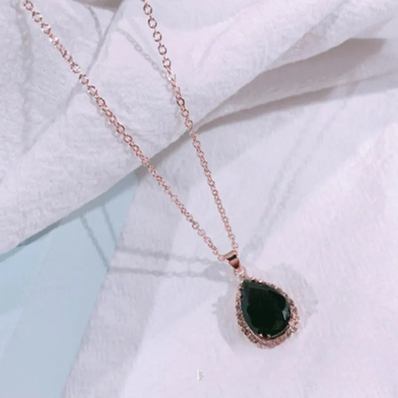 Rose gold water drop shape necklace with rhinestone geometric detailing in pink colour