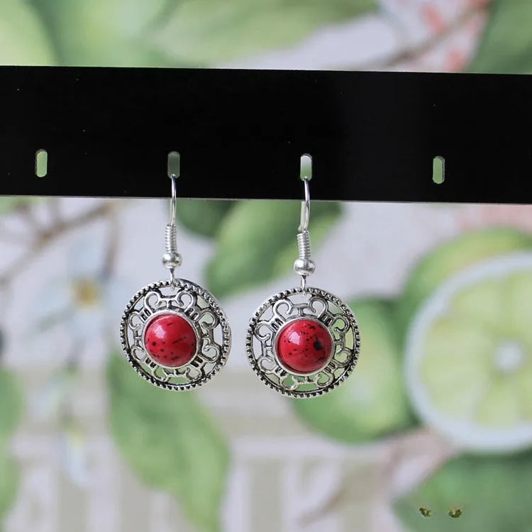Miao silver earrings with turquoise geometric flower disk and totem patterns