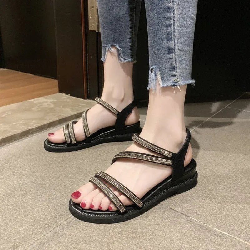Women's flat casual sandals in gold with rhinestone fairy detail and elastic band.