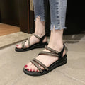 Women's flat casual sandals in gold with rhinestone fairy detail and elastic band.