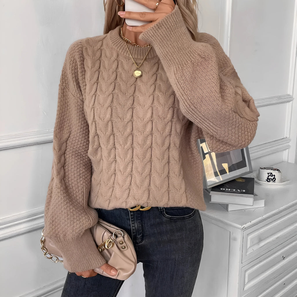 Women's beige loose-fit round neck casual pullover sweater on a hanger.
