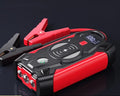 Red car jump starter with digital display and air pump accessory for 12V battery emergency starting
