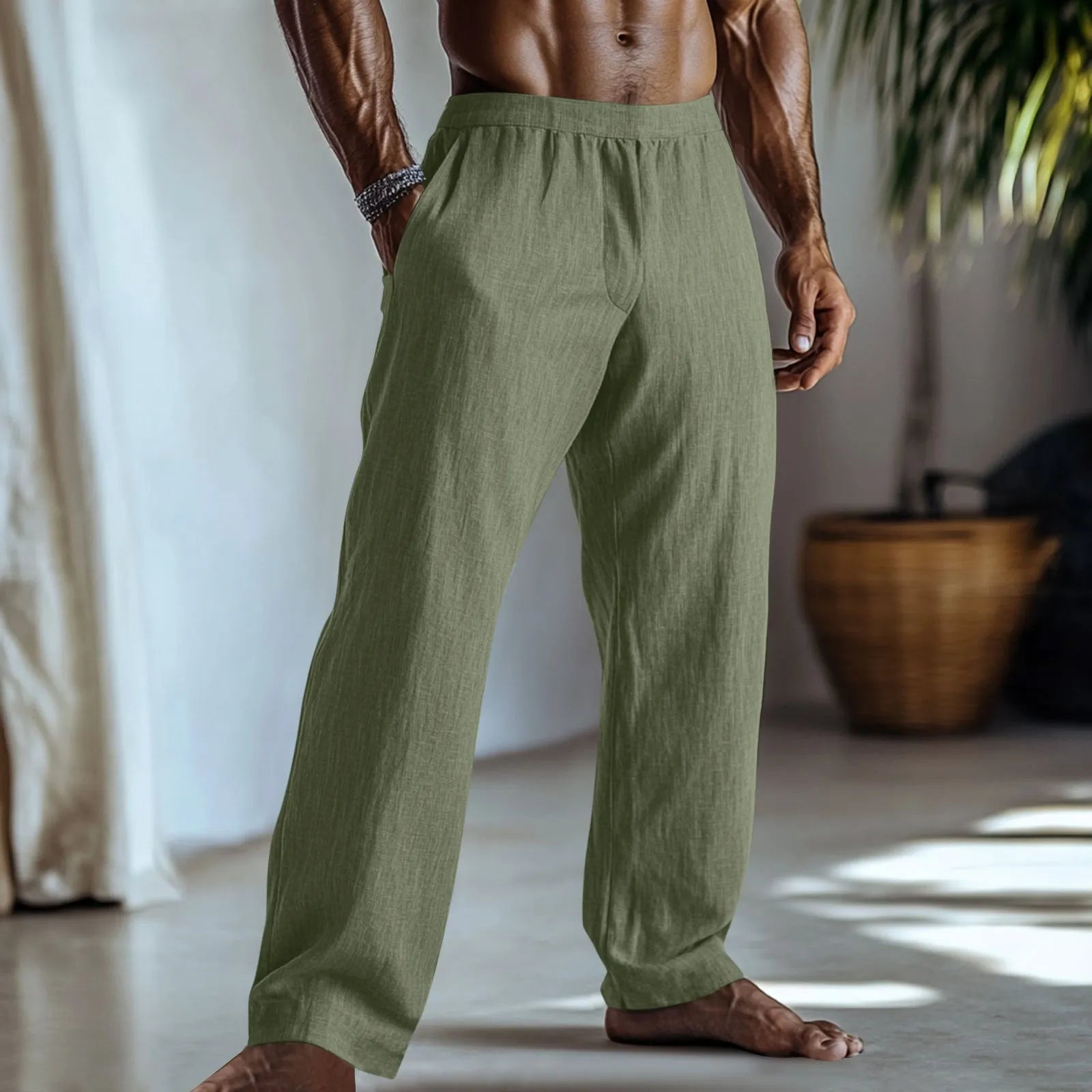 Straight leg cotton linen trousers in light green colour with visible front pockets on a plain background