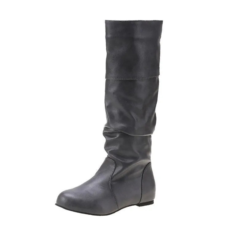 Women's black slip-on long boots with flat heel and round toe on a plain background.