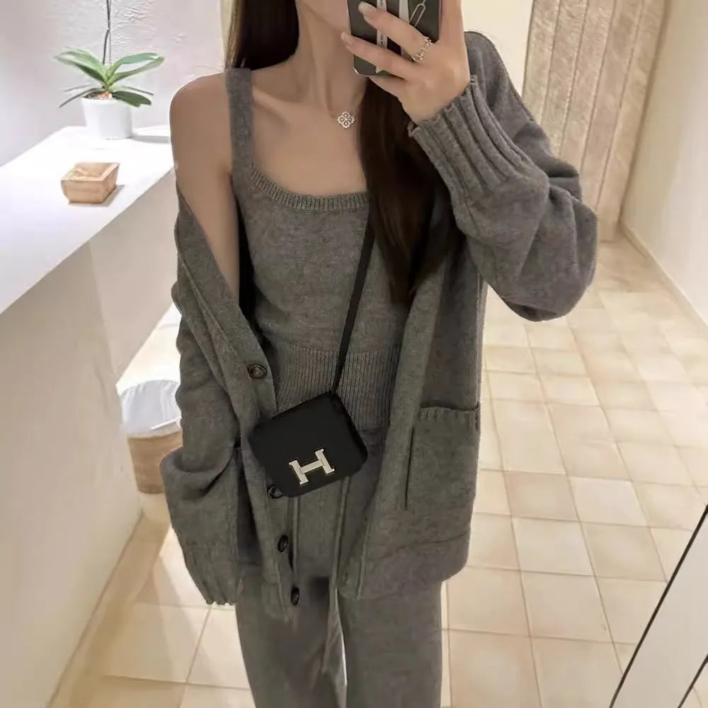Women's knit three-piece set showing cardigan coat, vest, and suspender trousers in beige colour