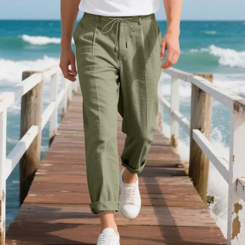 Men's light beige linen casual trousers with drawstring waist and straight-leg fit on a hanger.