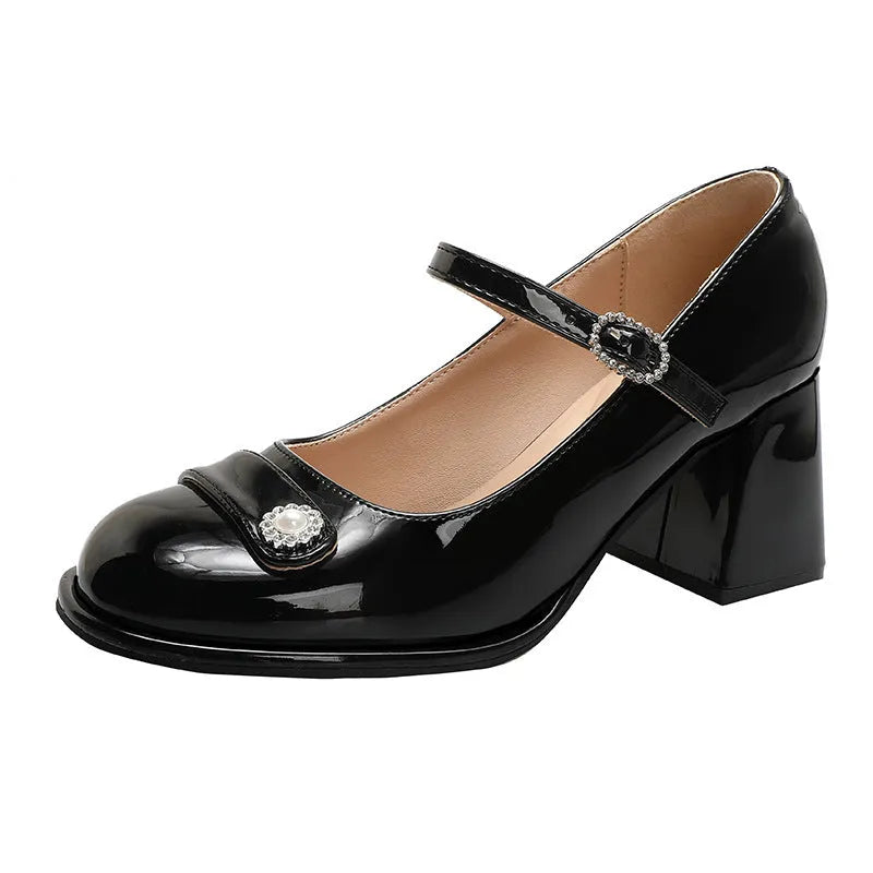 Women's black patent leather chunky heel shoes with round toe and buckle fastening, shown in a wide fit style.