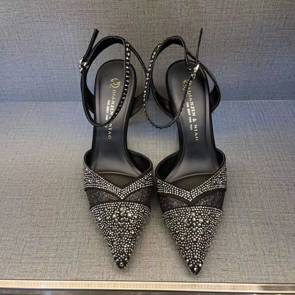 Women's silver high heels with hollow cut-out design and red stiletto heel sole.