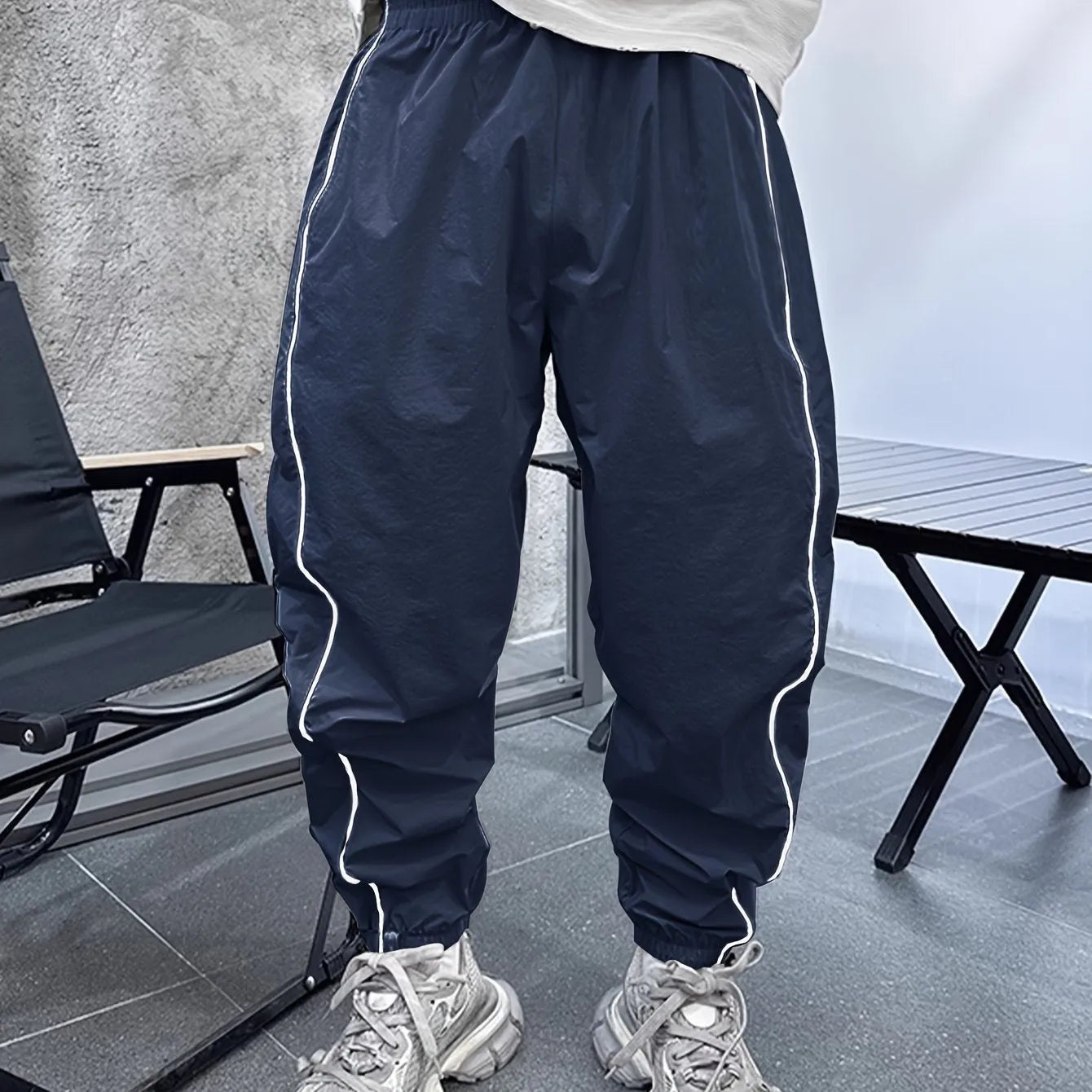 Men's loose blue bamboo fibre cropped sports trousers on a grey background