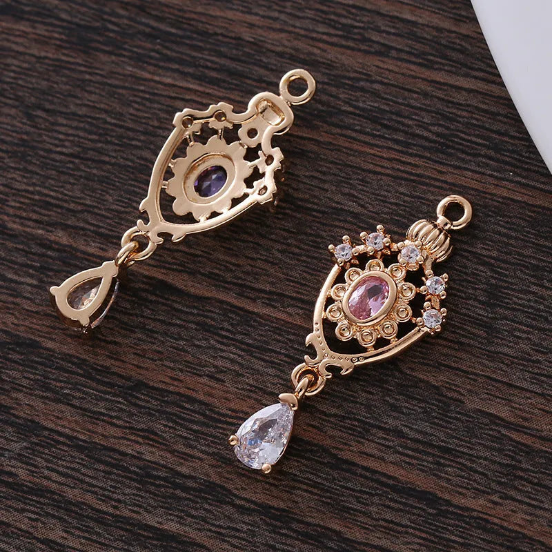 Water drop shaped pendant with crown design and micro inlaid zircon detail in electroplated copper.