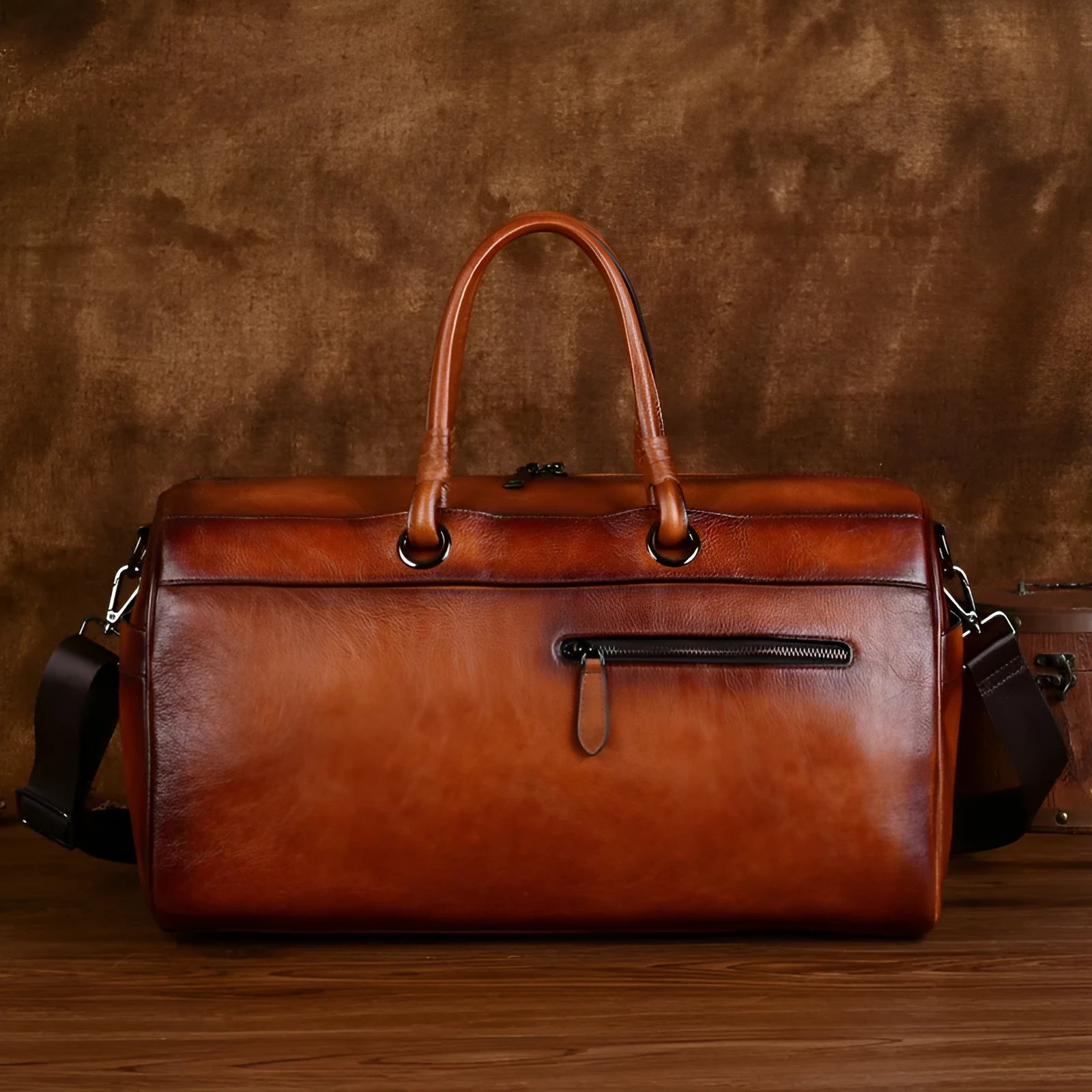 Handmade retro style leather travel bag in vintage brown colour showing expansion functionality