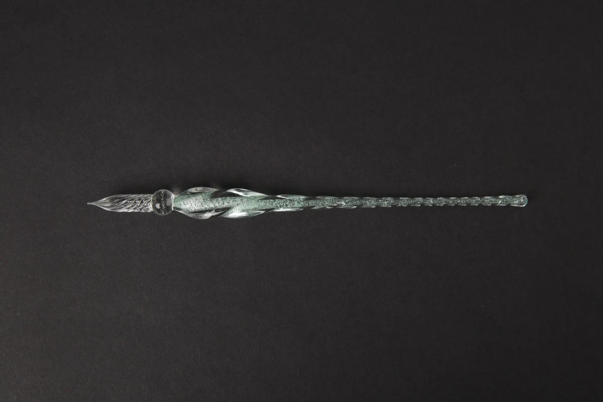 Transparent glass art pen with coloured ink dipped design in a gift box.